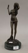 A bronze figure of a girl drying her hair