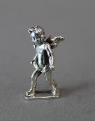 A small silver model of a cherub