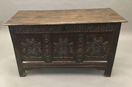 A 17th/18th century carved oak three panelled coffer.