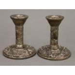 A pair of embossed silver candlesticks (11 troy ounces loaded)