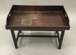 A 19th century mahogany butlers tray on a later stand.