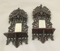 A pair of 19th century Black Forest carved wall mirrors