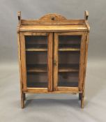 An early 20th century glazed oak bookcase