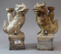 A pair of Chinese pottery dog-of-fo incense holders
