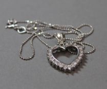 An 14 k white gold and diamond heart pendant on chain (4.