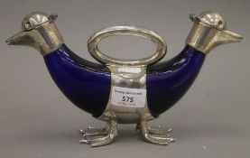 A silver plated double duck form claret jug