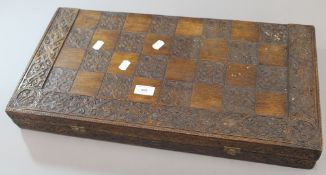 A carved oak chessboard