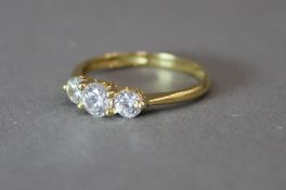 A 9 ct gold three stone ring (2.