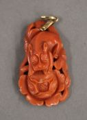 A Chinese carved coral pendant