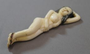 A bone figure of a nude lady