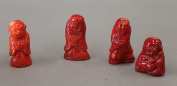 Four carved coral figures