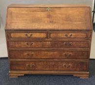 A George III oak and mahogany banded bureau. 120 x 53 cm, 104 cm high.