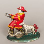 An American cast iron doorstop, modelled as a fireman and his dog. 19 cm high.