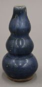 A small Chinese pottery blue ground triple gourd vase