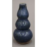 A small Chinese pottery blue ground triple gourd vase