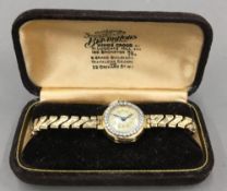 A 9 ct gold and diamond ladies watch, with plated strap (17.