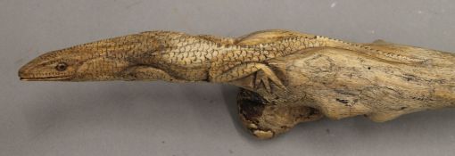 A carved walking stick, the handle worked with a lizard.