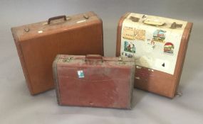 A quantity of vintage suitcases,