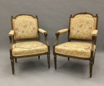 A pair of 19th century French upholstered carved giltwood open armchairs,