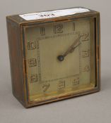 An Art Deco brass and enamel desk clock