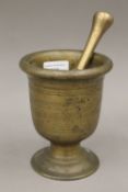 An antique bronze pestle and mortar