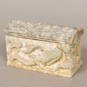 A carved and reconstituted stone model of a sarcophagus,