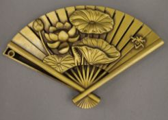 A bronze fan shaped box