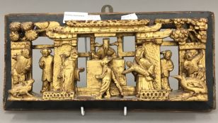 A Chinese, circa 1900, carved gilt wood panel worked with a scene from a Magistrates Court,