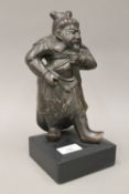 An antique patinated bronze model of Guan Yu on a later wooden base