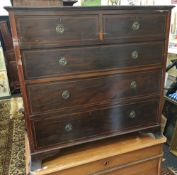 An Edwardian mahogany chest of two short over three long drawers, on splayed bracket feet,