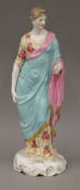 A 19th century porcelain figurine, dressed in flowing robes,