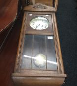 An oak cased Vienna wall clock