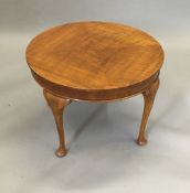 A walnut occasional table on cabriole legs,