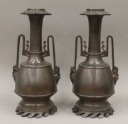 A pair of 19th century twin handled patinated metal vases