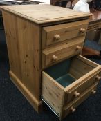 A modern pine two drawer filing cabinet