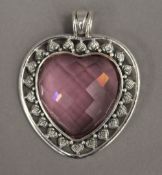 A silver heart shaped pendant