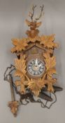 A Black Forest cuckoo clock worked with a stag's head