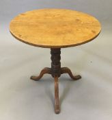 A 19th century mahogany tripod table, the block with period inscribed label and stamped TL.