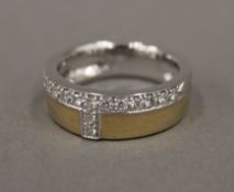 A 14 K two tone gold and diamond ring (7.