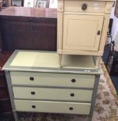 A painted chest of three long drawers, 104 cm wide, together with a painted bedside cupboard,