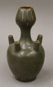 A Chinese celadon ground flower vase