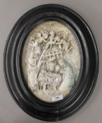 A 19th century Continental oval framed relief panel depicting the nativity