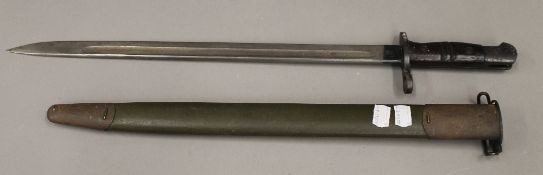 An American US WWI M1917 Enfield bayonet with scabbard by Winchester Arms,