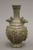 A Chinese porcelain archaistic vase, of baluster form with applied flanges.
