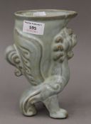 A Chinese celadon glazed pottery vase formed as a mythical beast