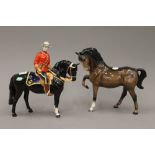 A Beswick model of a Mountie on horseback and a Beswick brown stallion