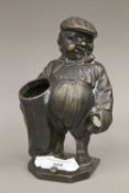 A bronze figure of a portly golfer