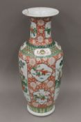 A large 19th century Chinese famille verte vase depicting figures in various pursuits