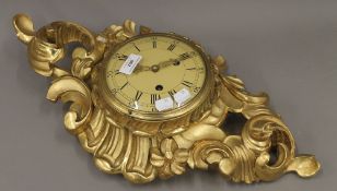 A giltwood cartel clock