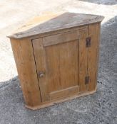 An 18th century pine hanging corner cupboard